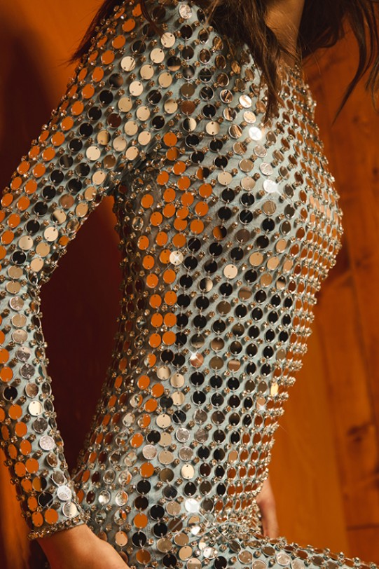 Close-up of a long sleeve dress covered in round metallic sequins in silver and copper media 2 of 4