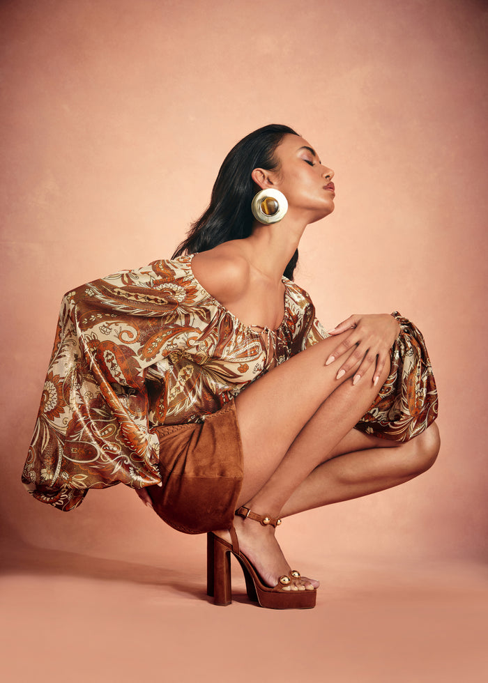 Arabella Silk Blouse styled with a caramel suede mini skirt and large gold hoop earrings. media 2 of 6