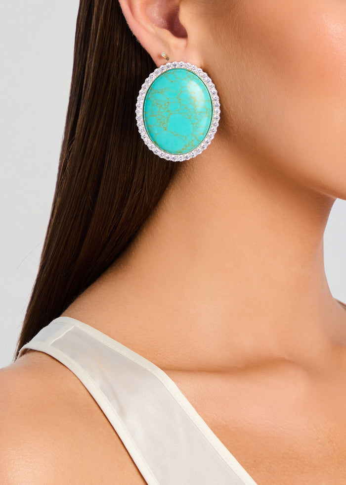 Fillipa Embellished turquoise oval earrings with a diamond halo worn on the ear media 4 of 4