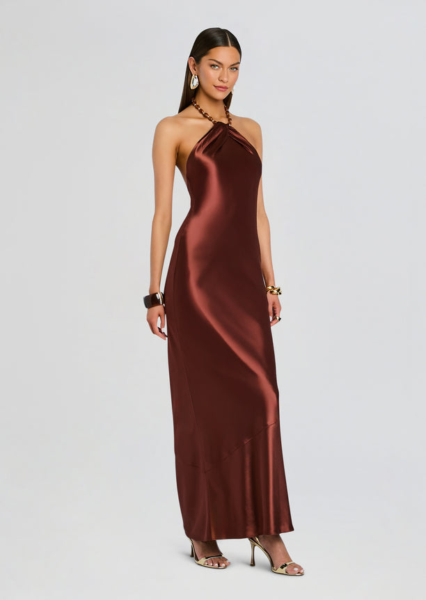 Anat Dress in bronze satin on a model with a twisted halter neckline and long flowing skirt
