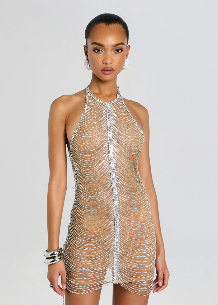 Model wearing a silver beaded halter dress with sheer nude base and cascading fringe media 5 of 5