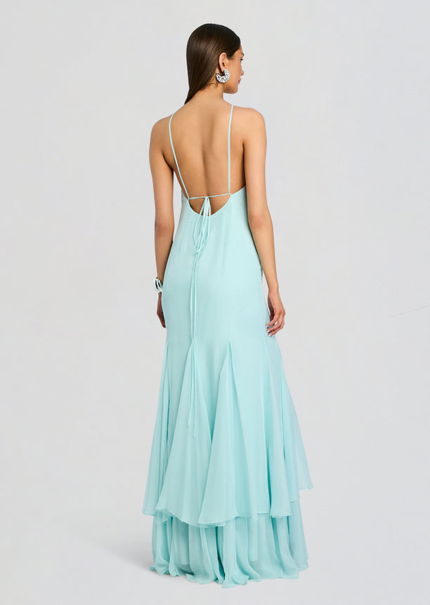 Back view of the pale blue Lirael Chiffon Dress with delicate straps and a tied open back, flowing layered hem.