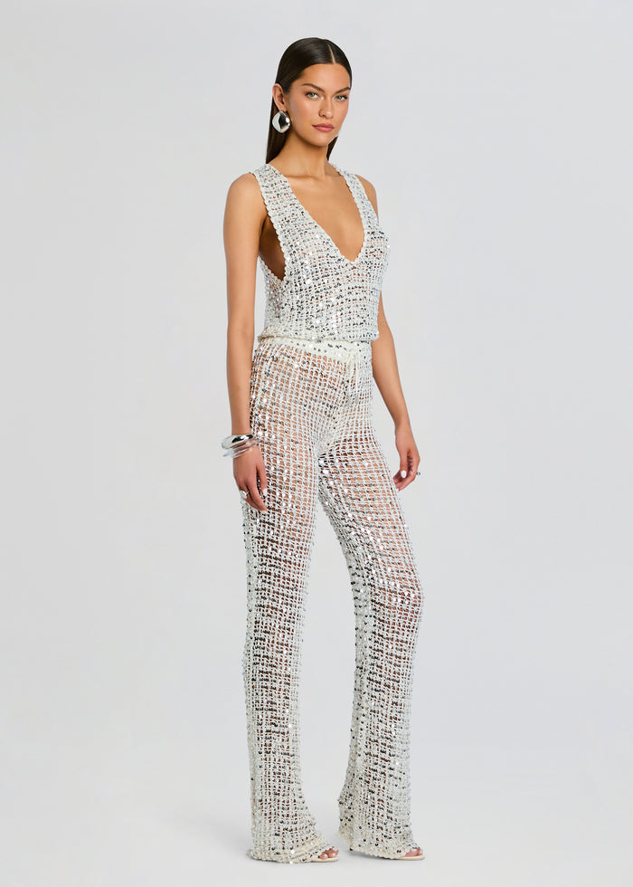 Model wearing Nirvana Sequin Crochet Jumpsuit front view full length in silver crochet with sequin embellishments media 3 of 5