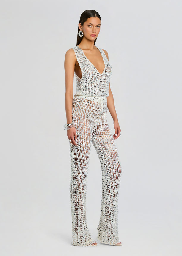 Model wearing Nirvana Sequin Crochet Jumpsuit front view full length in silver crochet with sequin embellishments