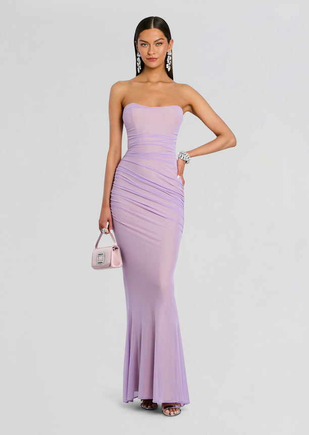 Quintessa Mesh Dress in lavender strapless gown with ruched bodice and mermaid flare, model holding a pink handbag