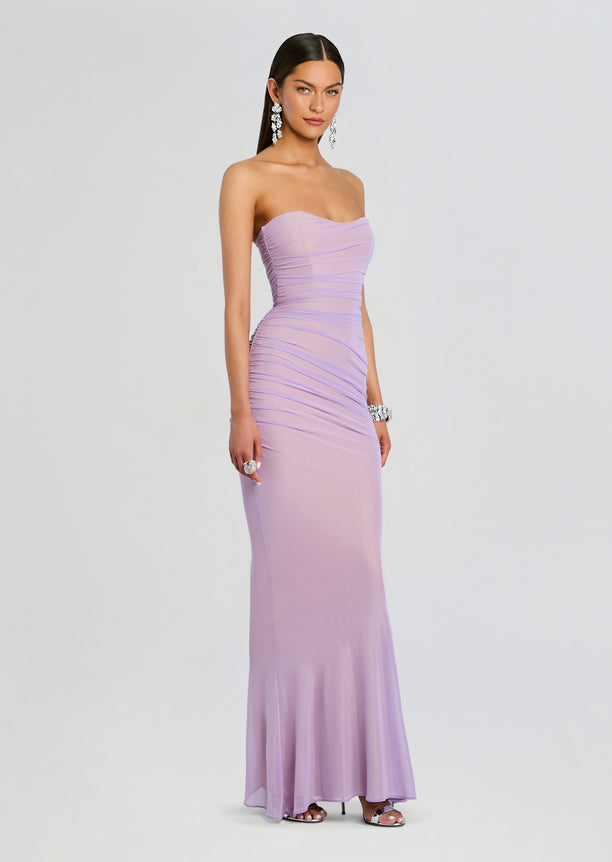 Model wearing a strapless lavender Quintessa Mesh Dress with ruched bodice and a floor-length skirt