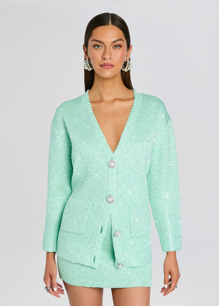 Sana Cardigan mint green sequin knit with large pearl buttons and matching skirt on a model media 1 of 5