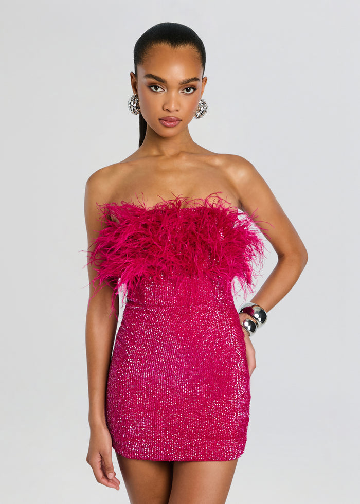 Front view of a model wearing a hot pink sequin feather dress with a dramatic feathered neckline and crystal earrings. media 5 of 5
