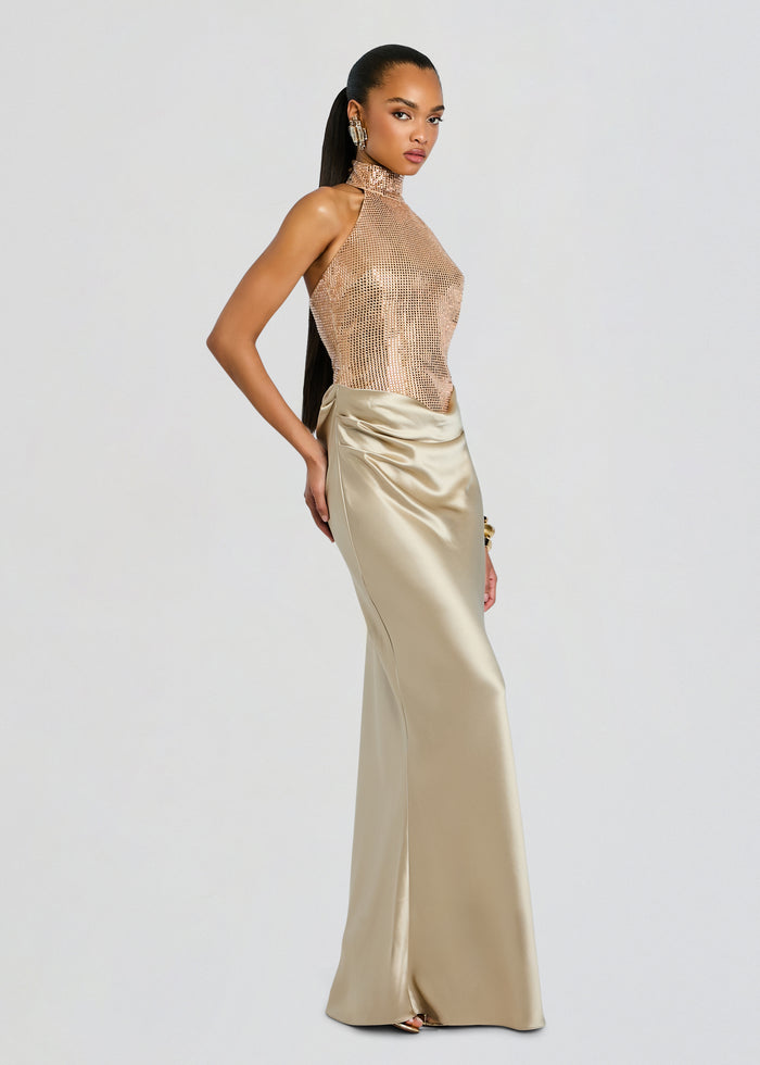 Side view of a model in the Vanya Embellished Dress with a shimmering mesh top and draped champagne satin skirt. media 4 of 6