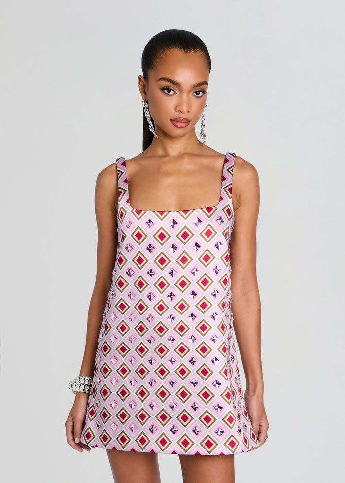 Front view of Zephyra Embellished Dress in pink diamond print on a model with statement earrings. media 6 of 6