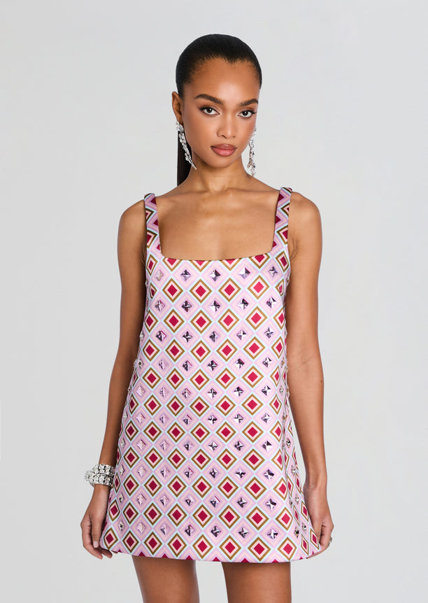 Front view of Zephyra Embellished Dress in pink diamond print on a model with statement earrings.