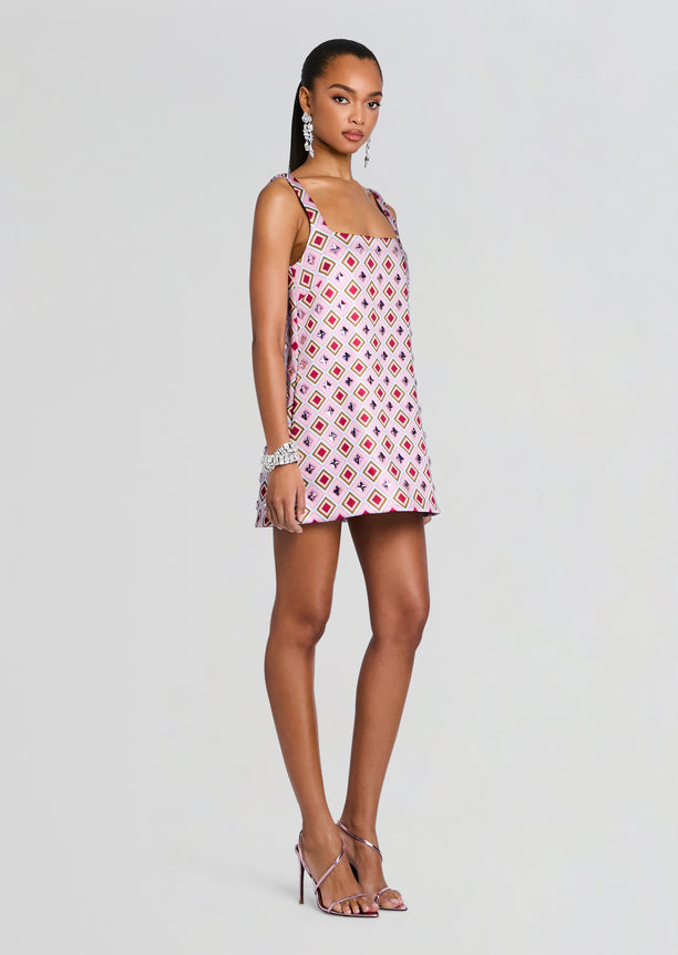 Zephyra Embellished Dress on a model in pink geometric print sleeveless mini dress with square motifs and strappy heels
