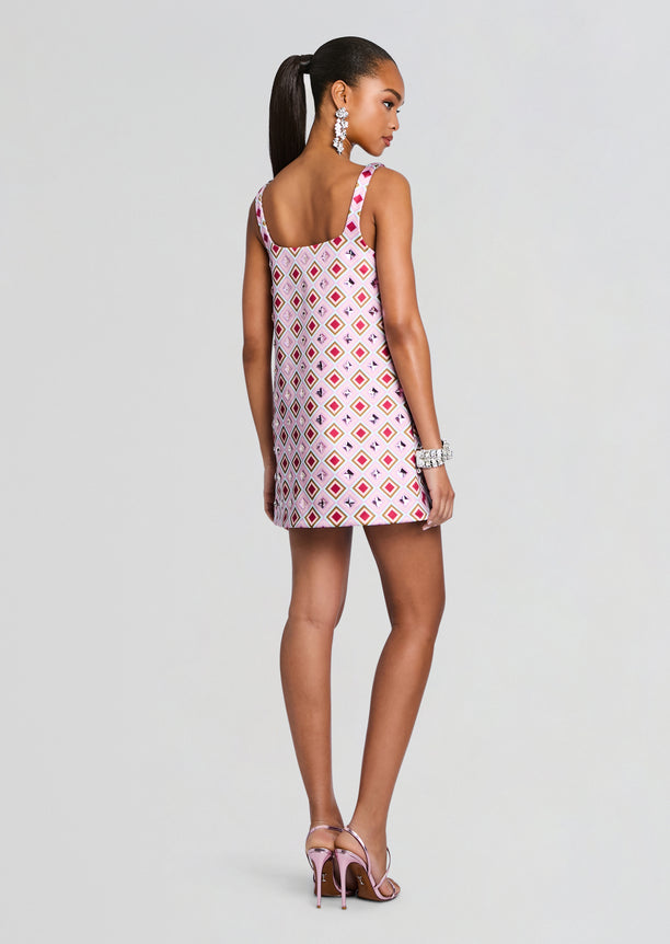 Back view of a pink diamond print Zephyra Embellished Dress worn by a model with a sleek ponytail.