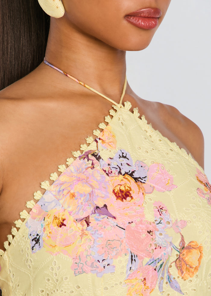 Close-up of Kysha Short Dress neckline in pale yellow lace with pastel floral embroidery and decorative edge trim. media 2 of 5
