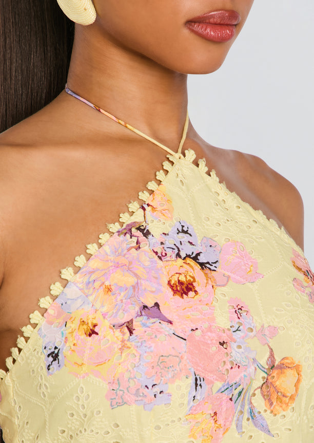 Close-up of Kysha Short Dress neckline in pale yellow lace with pastel floral embroidery and decorative edge trim.