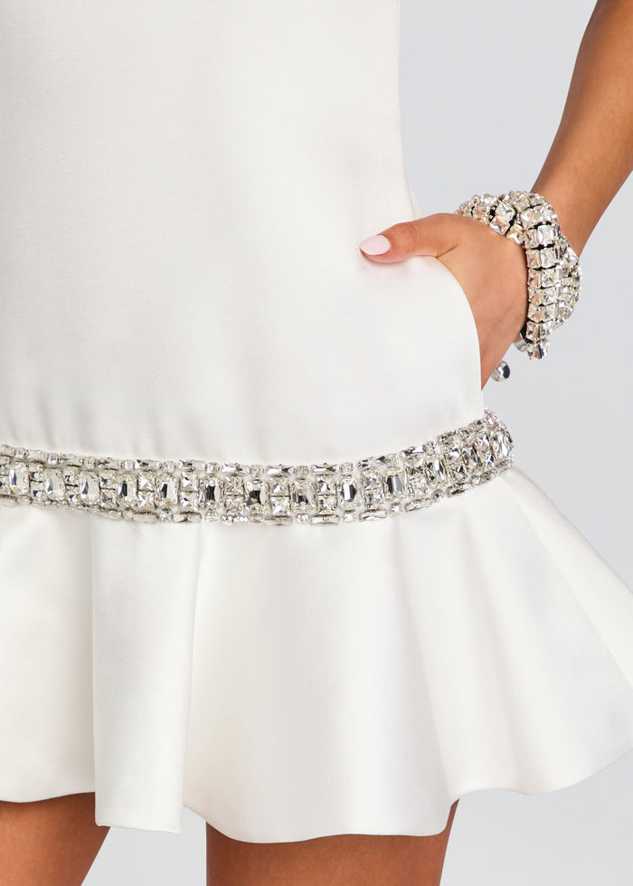 Close up of the Caelie dress at the waist showing the crystal belt and a hand resting in the side pocket media 2 of 5