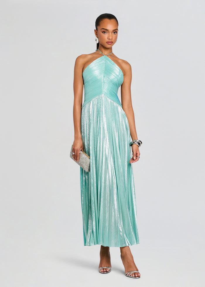 Ivee Dress on model with turquoise halter neck metallic pleated skirt and silver clutch media 1 of 5