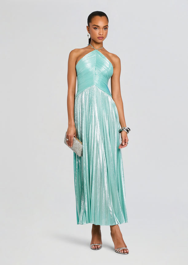 Ivee Dress on model with turquoise halter neck metallic pleated skirt and silver clutch