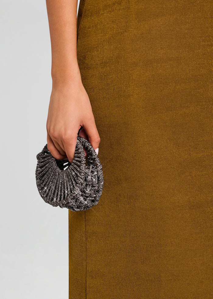Hand holding the Jaya mini bag, a small black and silver beaded purse against a mustard dress. media 2 of 5