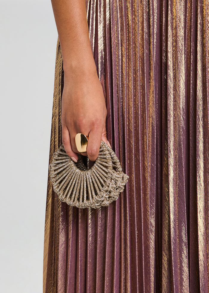 Jaya Mini Bag circular beaded clutch held in hand against a metallic pleated dress media 2 of 4