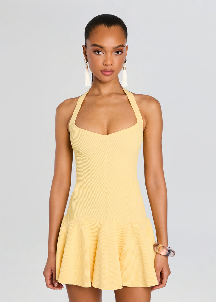Front view of a pale yellow ribbed knit halter dress with a fitted bodice and flared skirt media 5 of 5