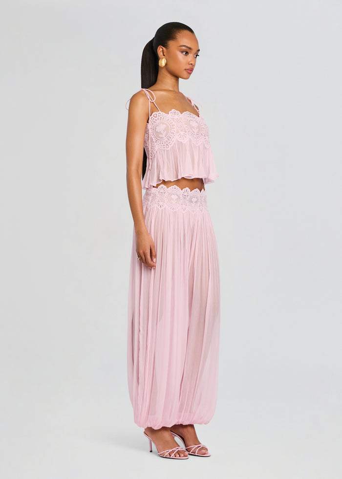 Model in a soft pink chiffon two-piece set with a lace crop top and matching flowing wide-leg pants. media 4 of 6