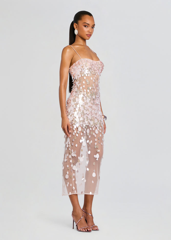Side view of a model wearing the Mischa Sequin Dress with a sheer nude base and scattered pink and silver sequins. media 3 of 5