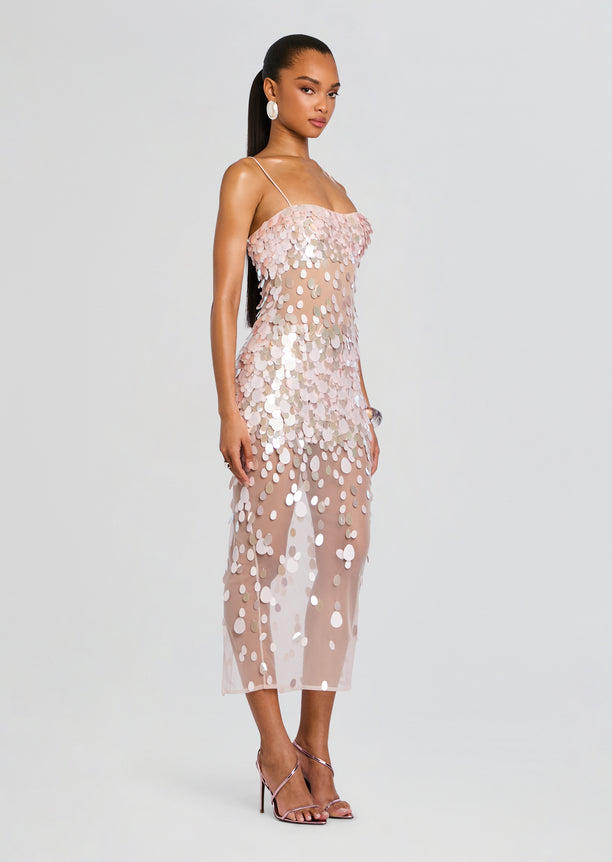 Side view of a model wearing the Mischa Sequin Dress with a sheer nude base and scattered pink and silver sequins.
