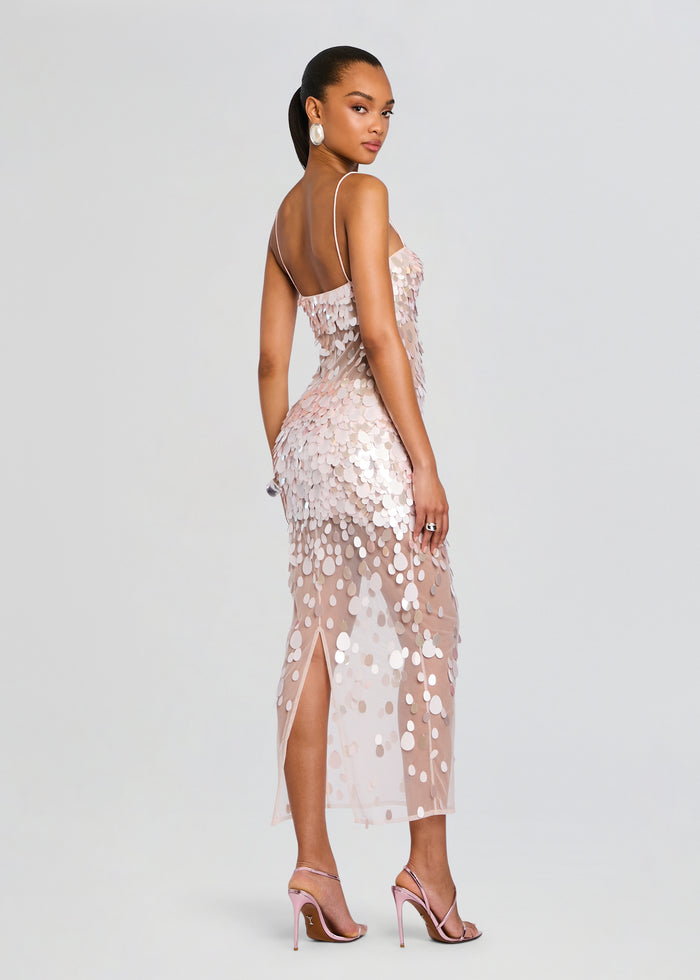Back view of a blush pink Mischa Sequin Dress with circular sequins, a sheer overlay, and a thigh-high slit. media 4 of 5