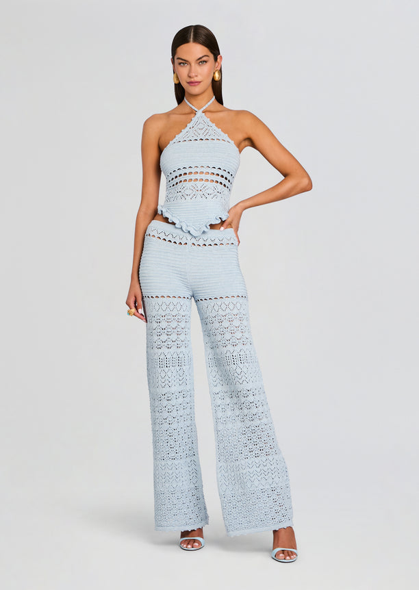 Model wearing Ornelie Crochet Pant in light blue crochet fabric with wide legs and lace panels