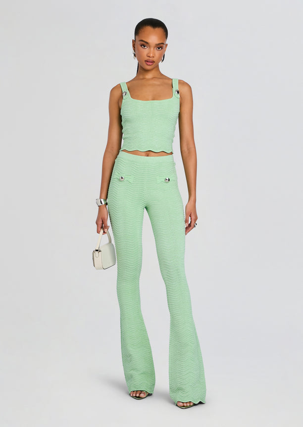 Mint green rib knit crop top with wide straps on a model.