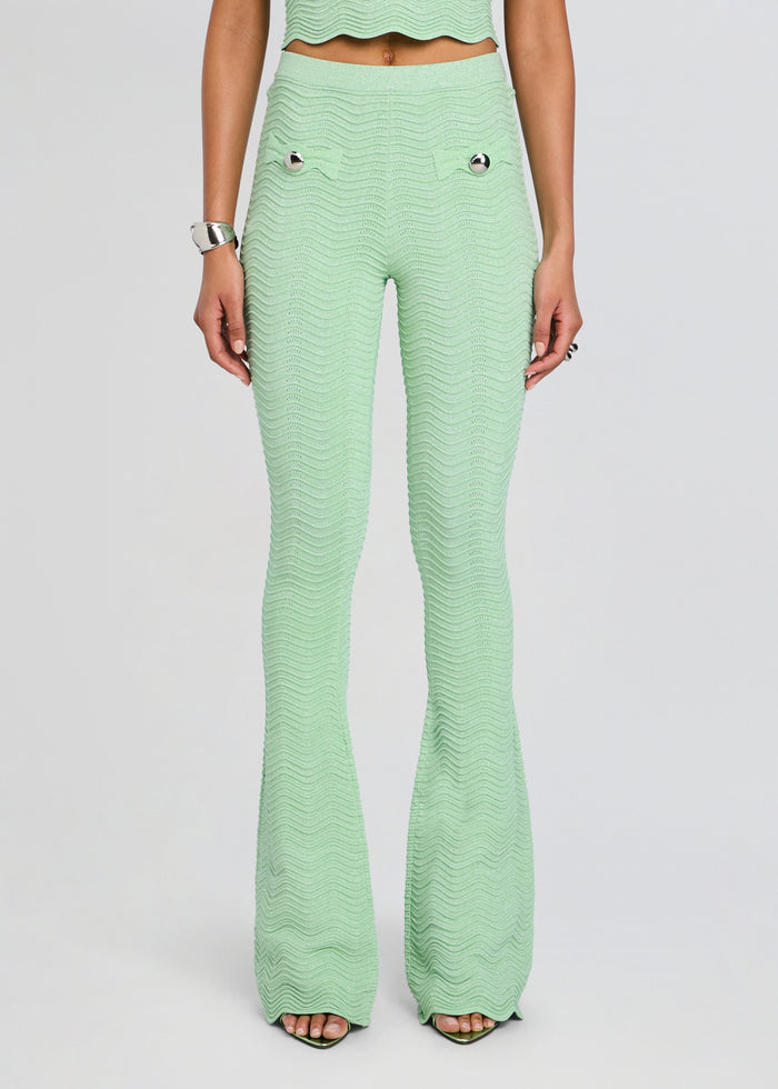Mint green rib knit flare pants with a wavy texture and silver buttoned pockets. media 1 of 5