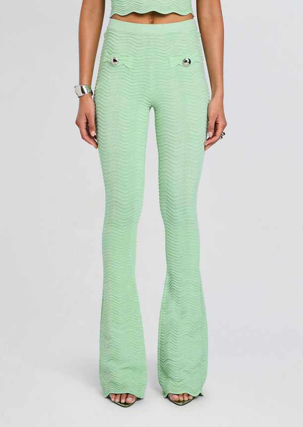 Mint green rib knit flare pants with a wavy texture and silver buttoned pockets.