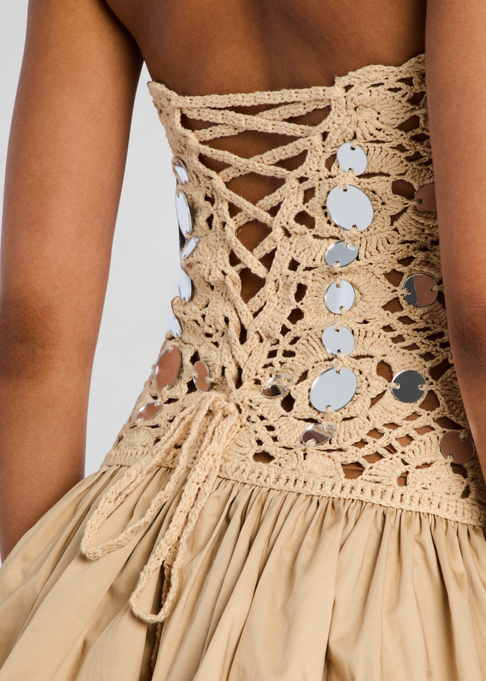 Back close up of Aliane Crochet Dress featuring lattice crochet, crisscross lacing and silver round discs. media 2 of 5
