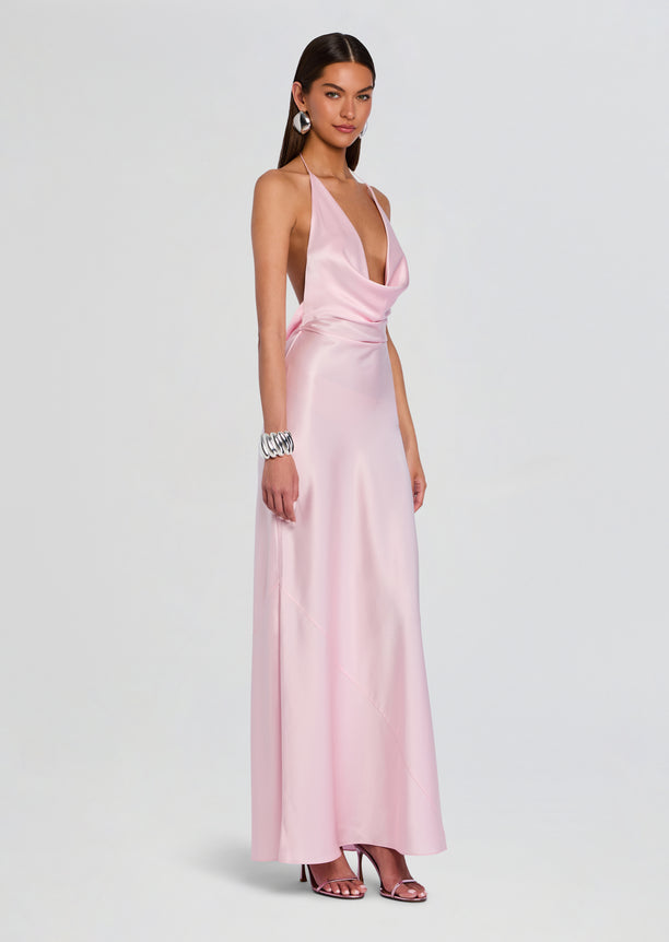 Side view of the pink satin Cinque Terre Dress on a model showing the draped waist and full-length skirt