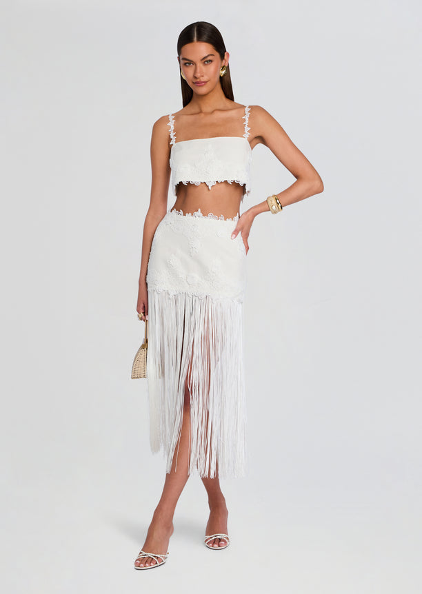Amaris Skirt shown as a white lace fringe midi skirt with a high waist and long fringe hem.