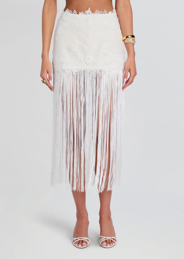 Close up of the Amaris skirt waist showing floral lace pattern and long white fringe