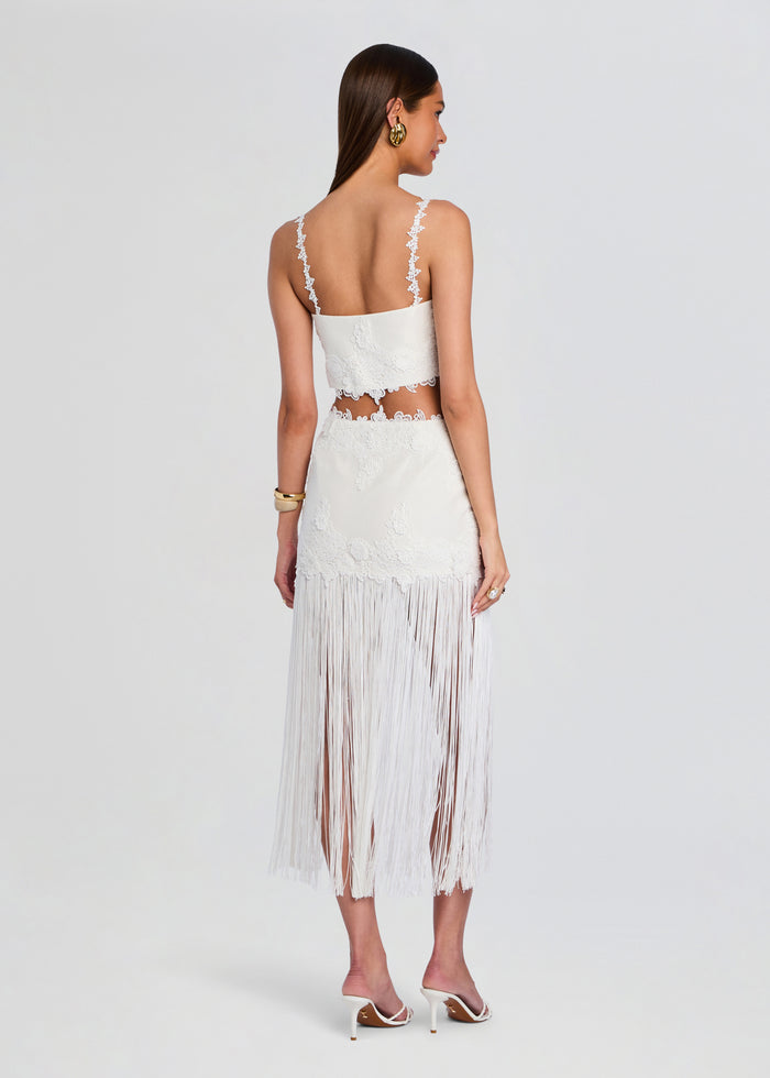 Back view of the white lace two piece with floral edges and a long fringe skirt on a model media 5 of 5
