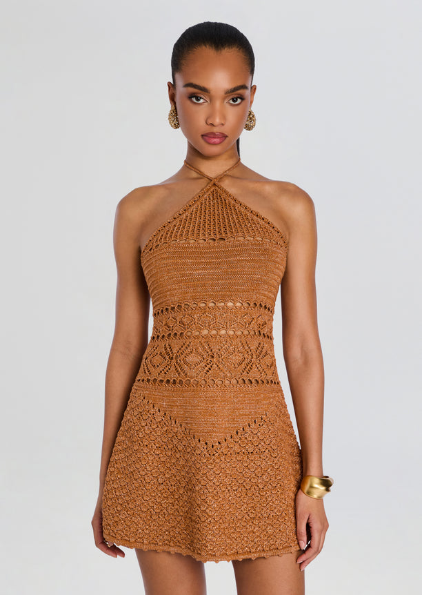 Copper crochet halter dress with high neck and fitted silhouette on a model