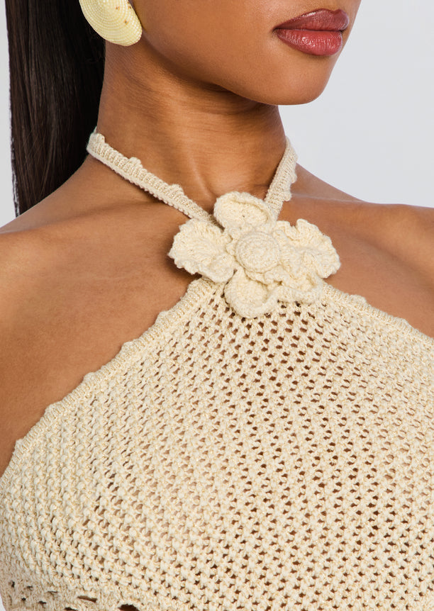 Ivory crochet halter top with a central flower applique at the neckline