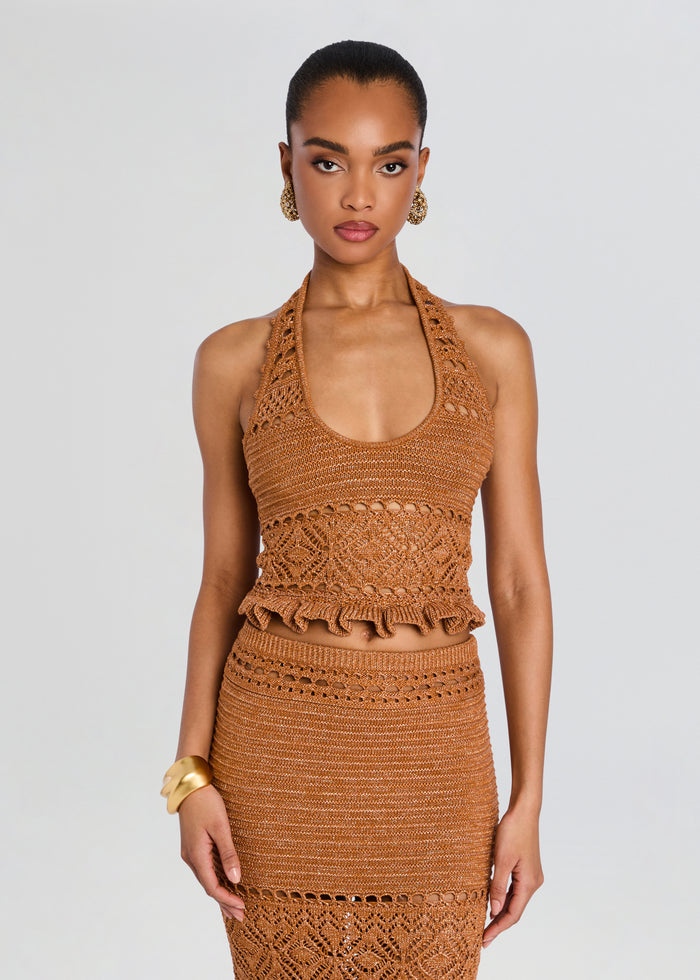 Model wearing copper Laurine Crochet Top with a matching crochet skirt and gold accessories. media 1 of 5
