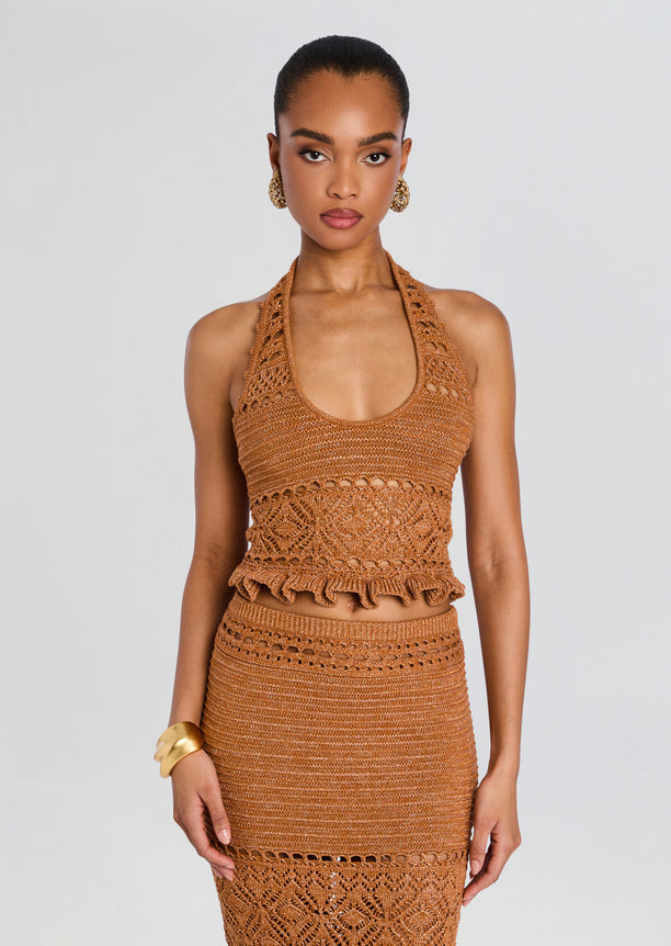 Model wearing copper Laurine Crochet Top with a matching crochet skirt and gold accessories.
