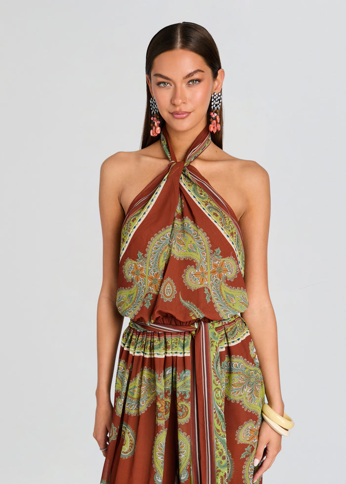 Woman wearing a patterned halter top dress on a plain background media 5 of 5