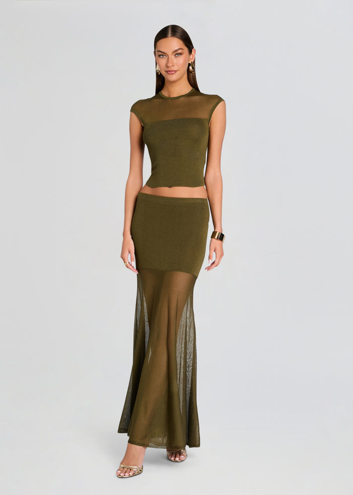 Woman wearing an olive green outfit with a top and long skirt on a light gray background media 2 of 5