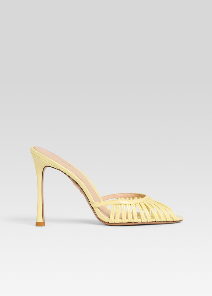 Allistair Sandal in pale yellow with woven toe straps and a slender heel seen from the side media 1 of 5