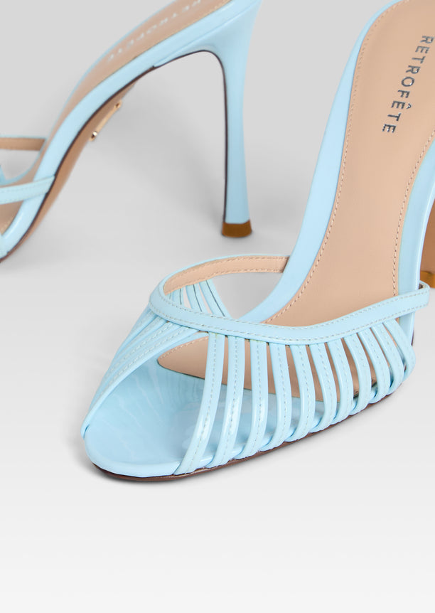 Close-up of light blue Allistair Sandal showing woven front straps and beige footbed