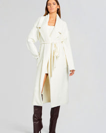 Athena Boucle Robe white boucle coat belted at the waist worn over a matching outfit with knee high brown boots
