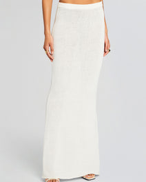 Cream knit Kora Skirt on a model from waist to floor paired with a white top and sandals