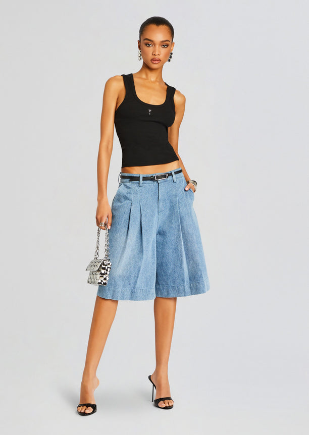 Model wearing the Amani Tank black ribbed top with knee length denim culottes a silver handbag and high heel sandals