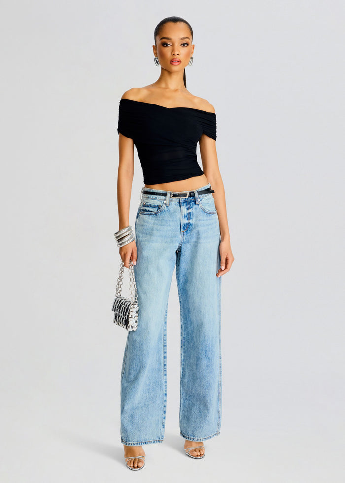 Model wearing Aruba Mesh Top a black off the shoulder cropped top with ruched detailing, paired with light denim. media 5 of 5
